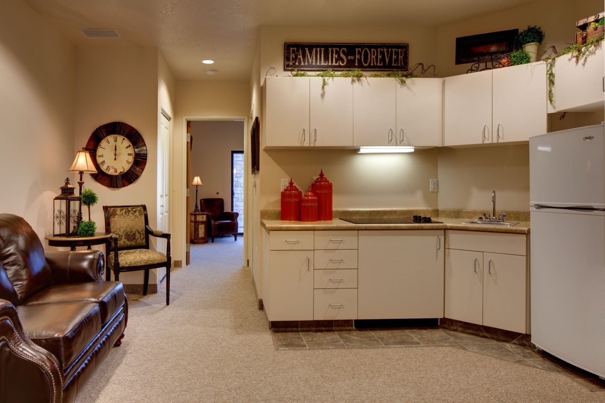 A cozy modern kitchen interior with white cabinets and decorative elements.