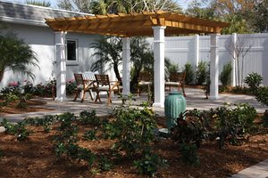 A relaxing garden patio with a pergola and outdoor seating area.