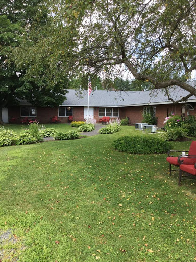 A peaceful home with a well-maintained garden and outdoor seating area.