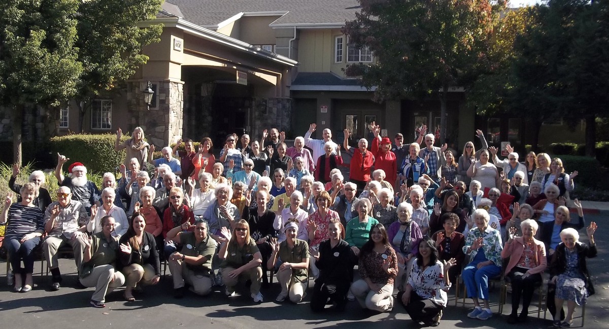A large group of people gathered outside a building for a community event.