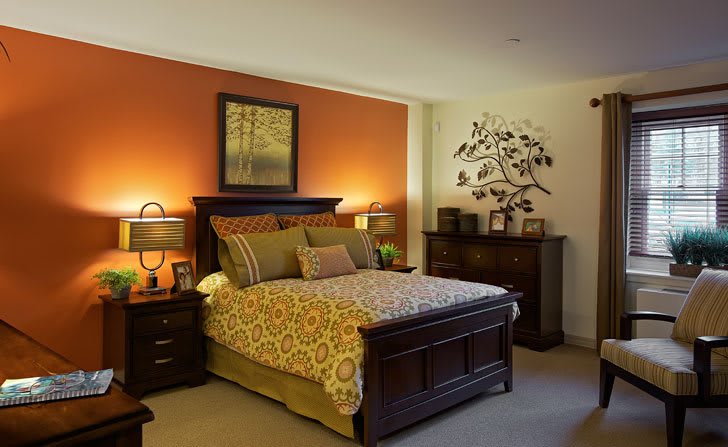 A cozy bedroom with warm colors and elegant furniture.
