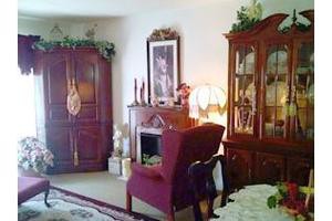 A cozy, traditionally-styled living room with warm lighting and elegant furniture.