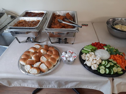 A delicious spread featuring a variety of dishes, bread rolls, and fresh vegetables.