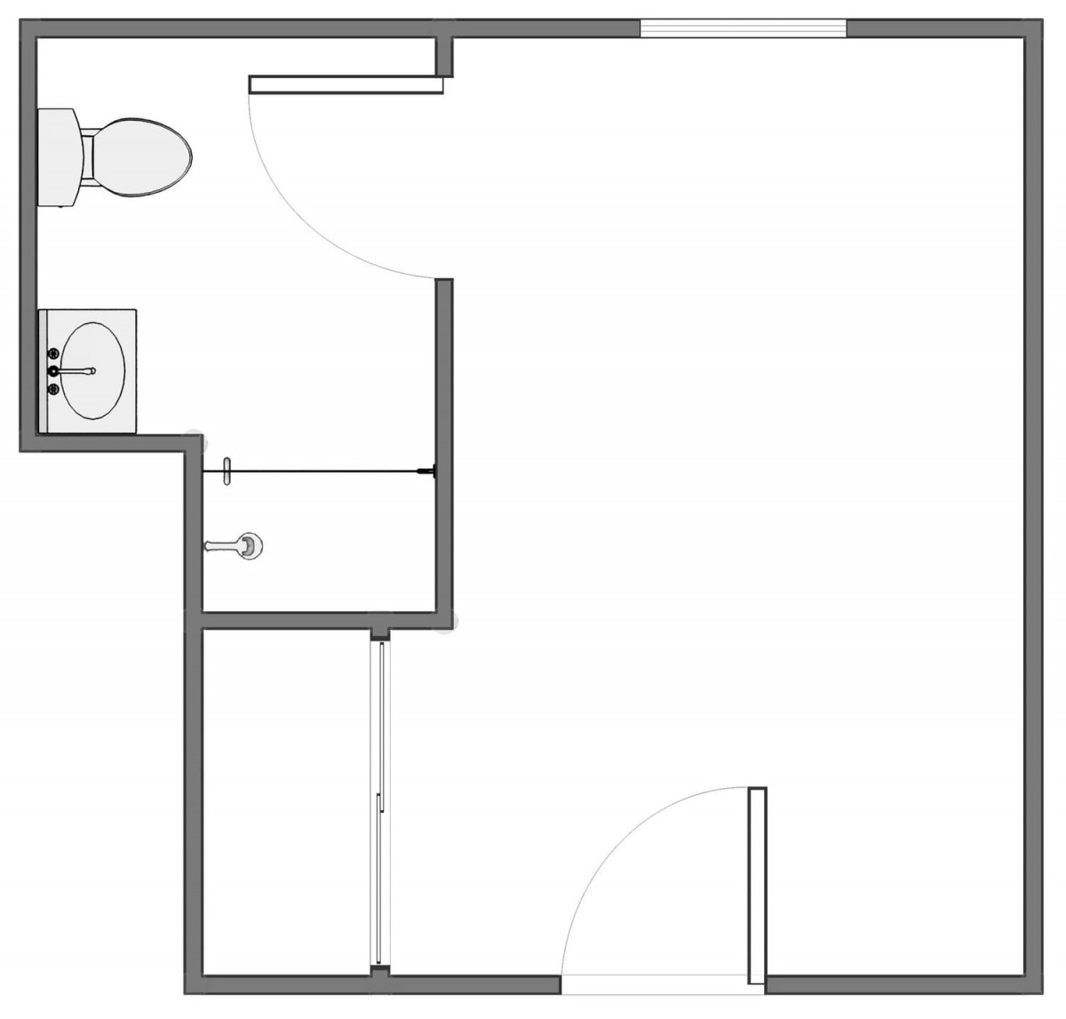 A simple floor plan featuring a bathroom layout with a toilet and sink, alongside an open space area.