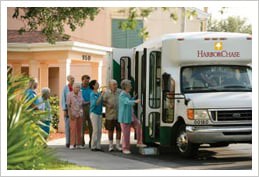 A group of senior citizens boarding a community bus.