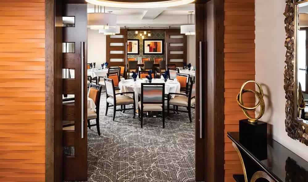 A modern restaurant dining area with neatly arranged tables and stylish decor.