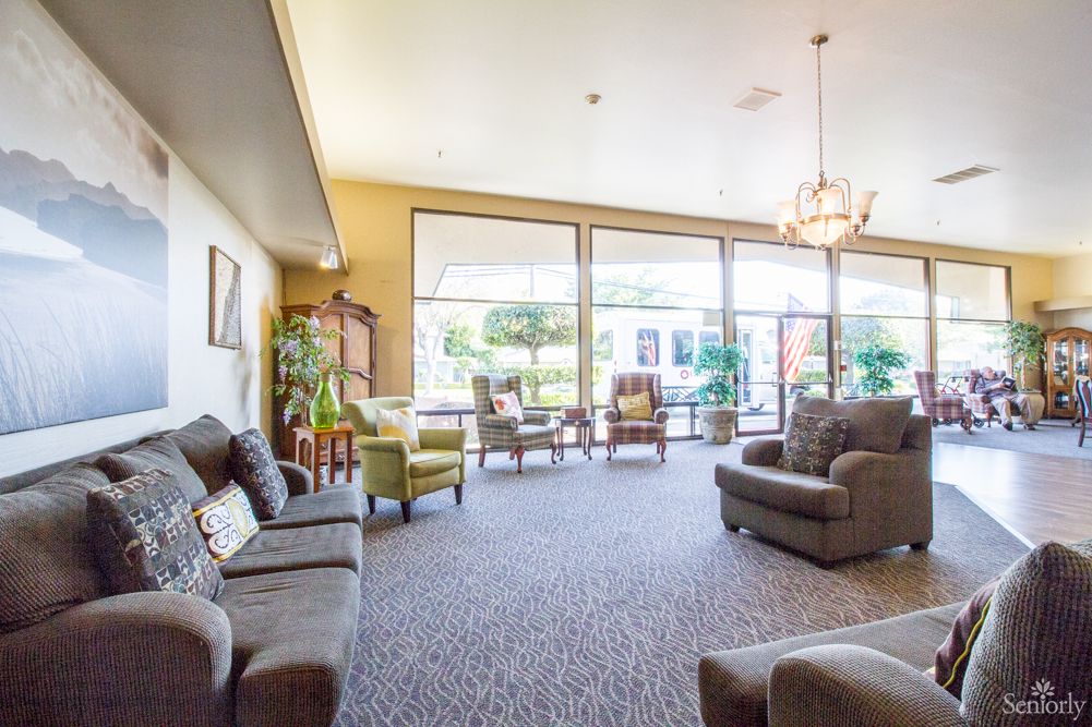 A bright and spacious living room with comfortable seating and large windows.
