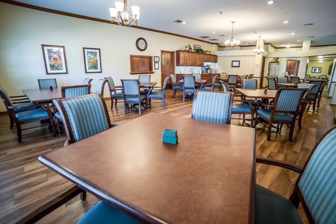 A well-furnished dining area with neatly arranged tables and chairs.