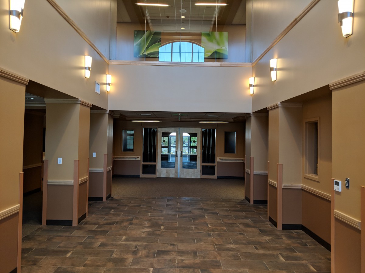 A well-lit hallway with modern architecture leading to an entrance.