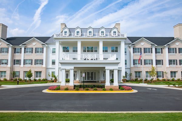 A large residential building with classical architecture and landscaped surroundings.