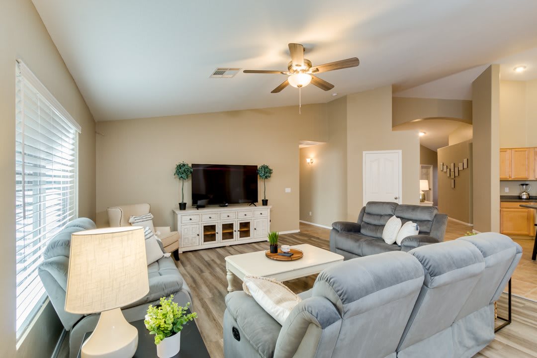 Modern living room with comfortable seating and a large TV.