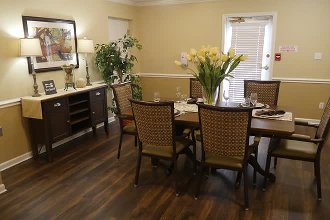 A cozy dining room set with a table, chairs, and elegant decor.