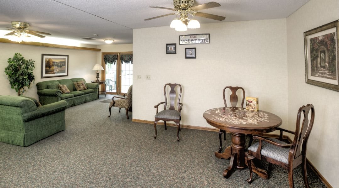 A cozy living room with classic furniture and a ceiling fan.