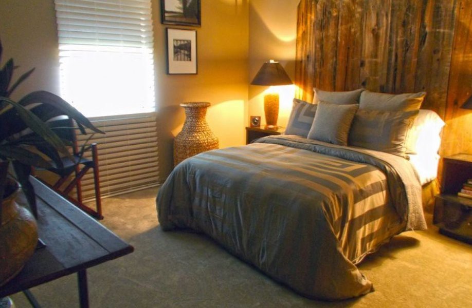 A cozy bedroom with warm lighting and wooden accents.