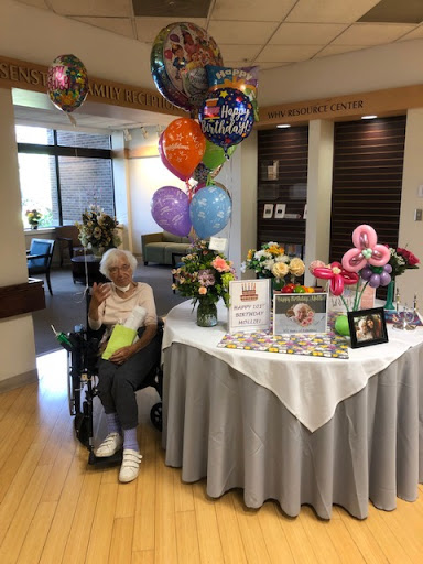 A joyful celebration with balloons and flowers, honoring a cherished moment.