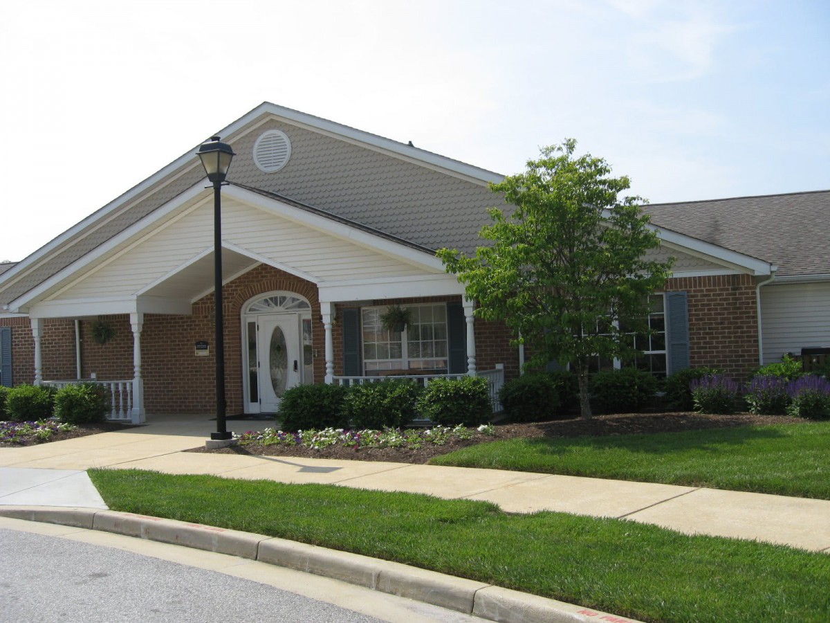 A suburban house with a well-maintained lawn and a lamp post in front.
