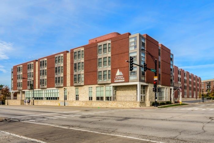A modern brick building located at a city street intersection.