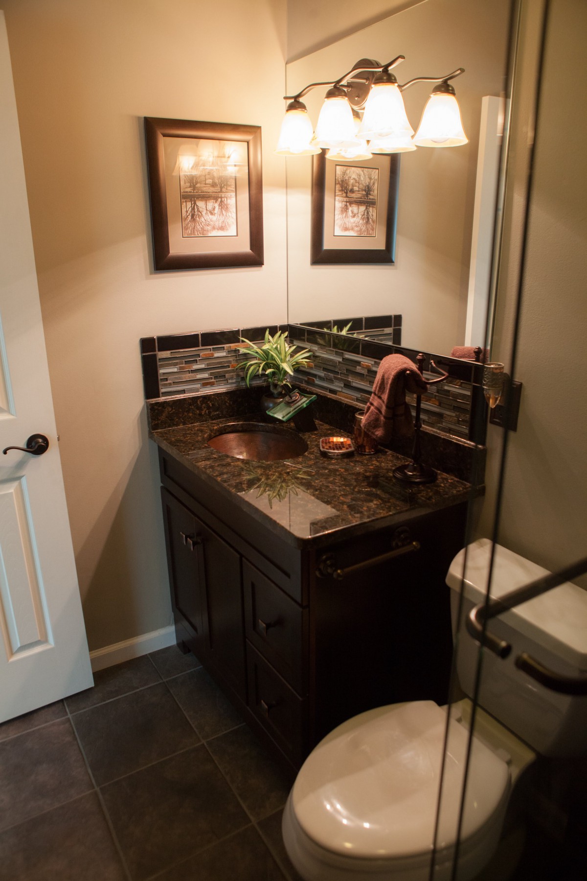A cozy bathroom with a dark wood vanity and stylish decor.