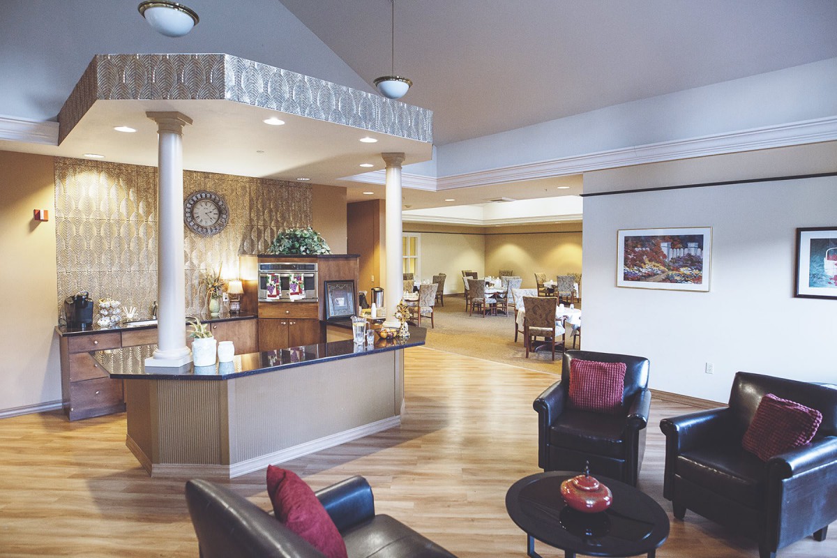 A spacious and elegantly decorated reception area with comfortable seating and decorative columns.