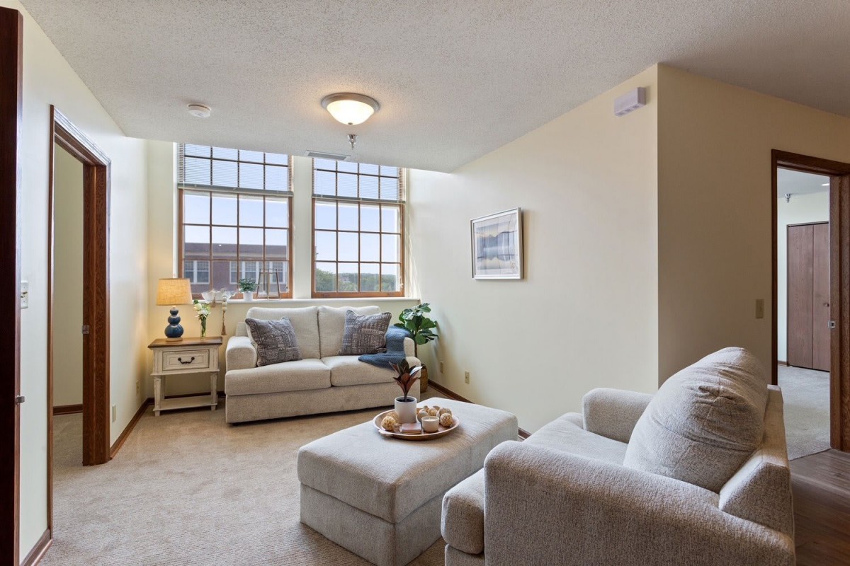 A cozy living room with comfortable sofas and large windows allowing natural light.