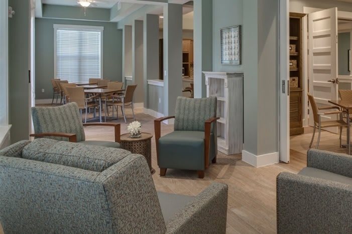 A cozy living room with comfortable seating and dining area.