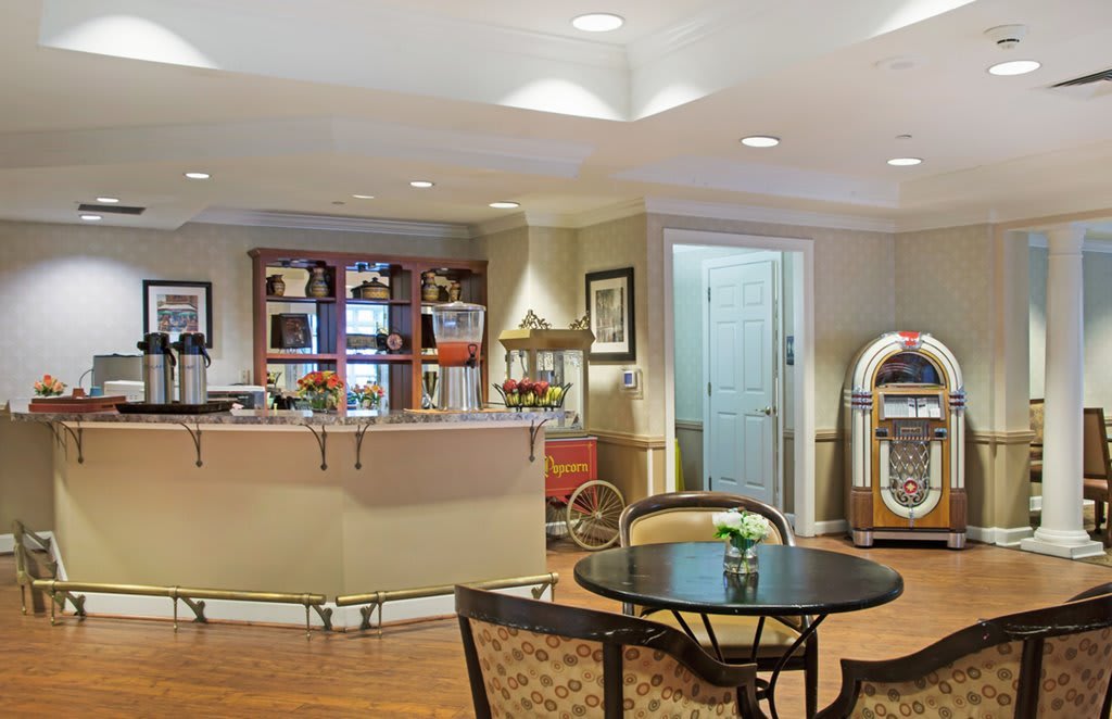A cozy lounge area with a reception desk and jukebox.