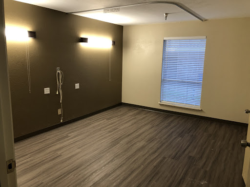 An empty room featuring modern design elements and warm lighting.