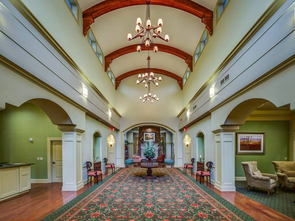 A grand hallway featuring chandeliers and traditional architectural details.