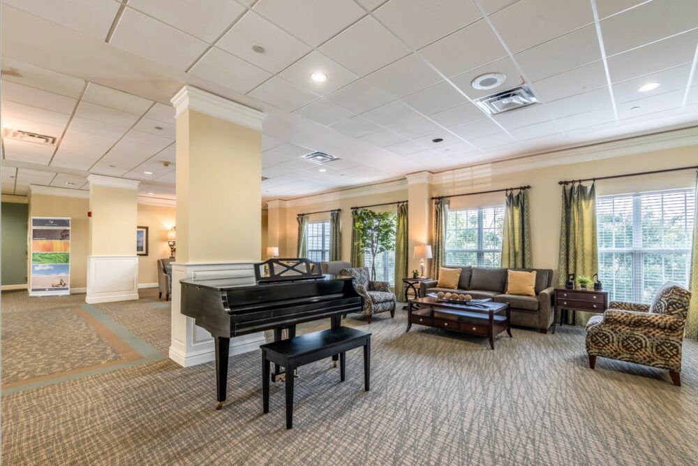 A spacious lobby featuring a grand piano and comfortable seating areas.