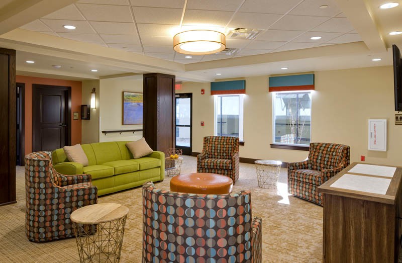 A modern lobby with vibrant seating and elegant lighting.
