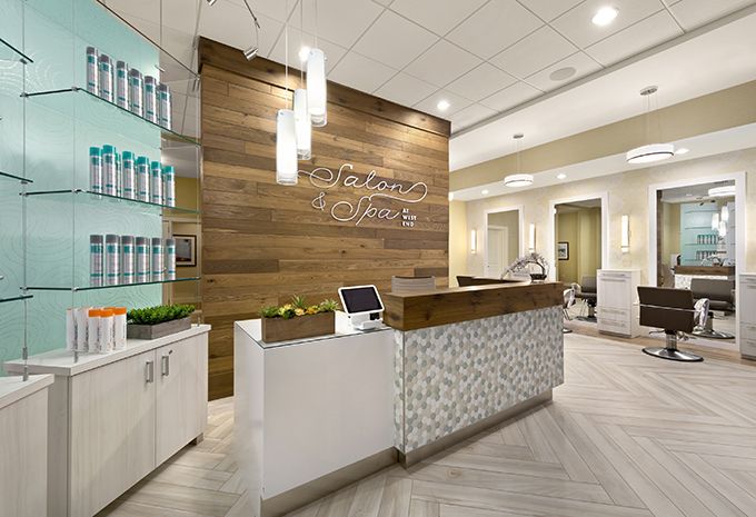A modern spa reception area with wood paneling and elegant lighting.