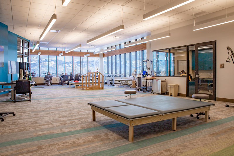 A spacious and modern rehabilitation center equipped with various exercise equipment for physical therapy.