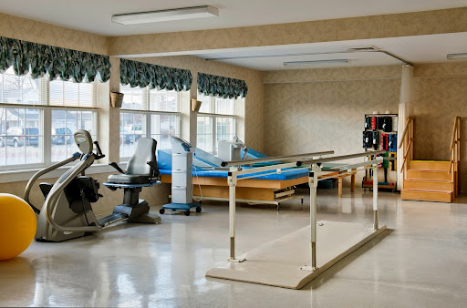A well-equipped physical therapy room featuring exercise equipment and rehabilitation aids.