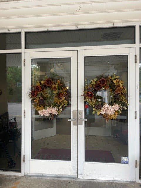 Glass doors adorned with festive wreaths.