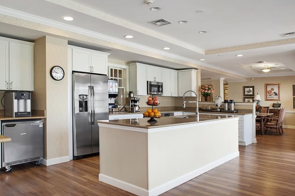 A spacious modern kitchen with a large island and stainless steel appliances.