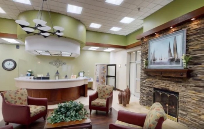 A cozy waiting room with comfortable seating and a reception desk.