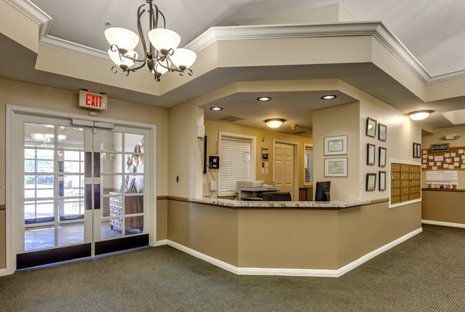 A welcoming reception area featuring a chandelier and spacious counter.