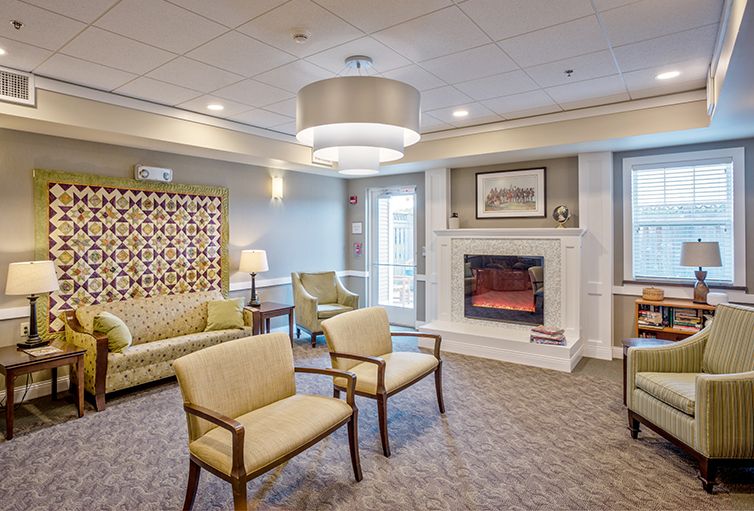 A modern living room with comfortable seating and a cozy fireplace.