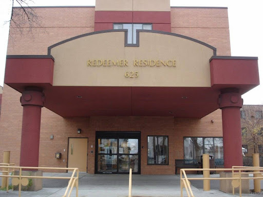 Main entrance of a community building, featuring a prominent sign.