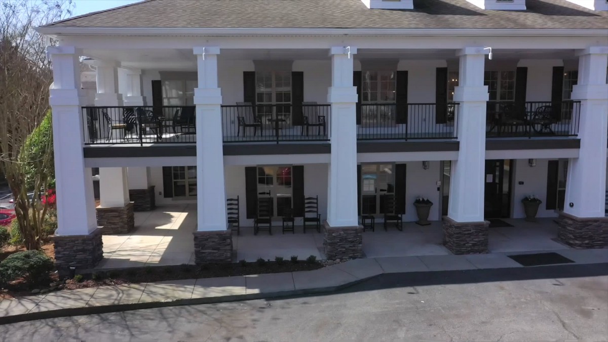 A two-story building with prominent columns and balconies.
