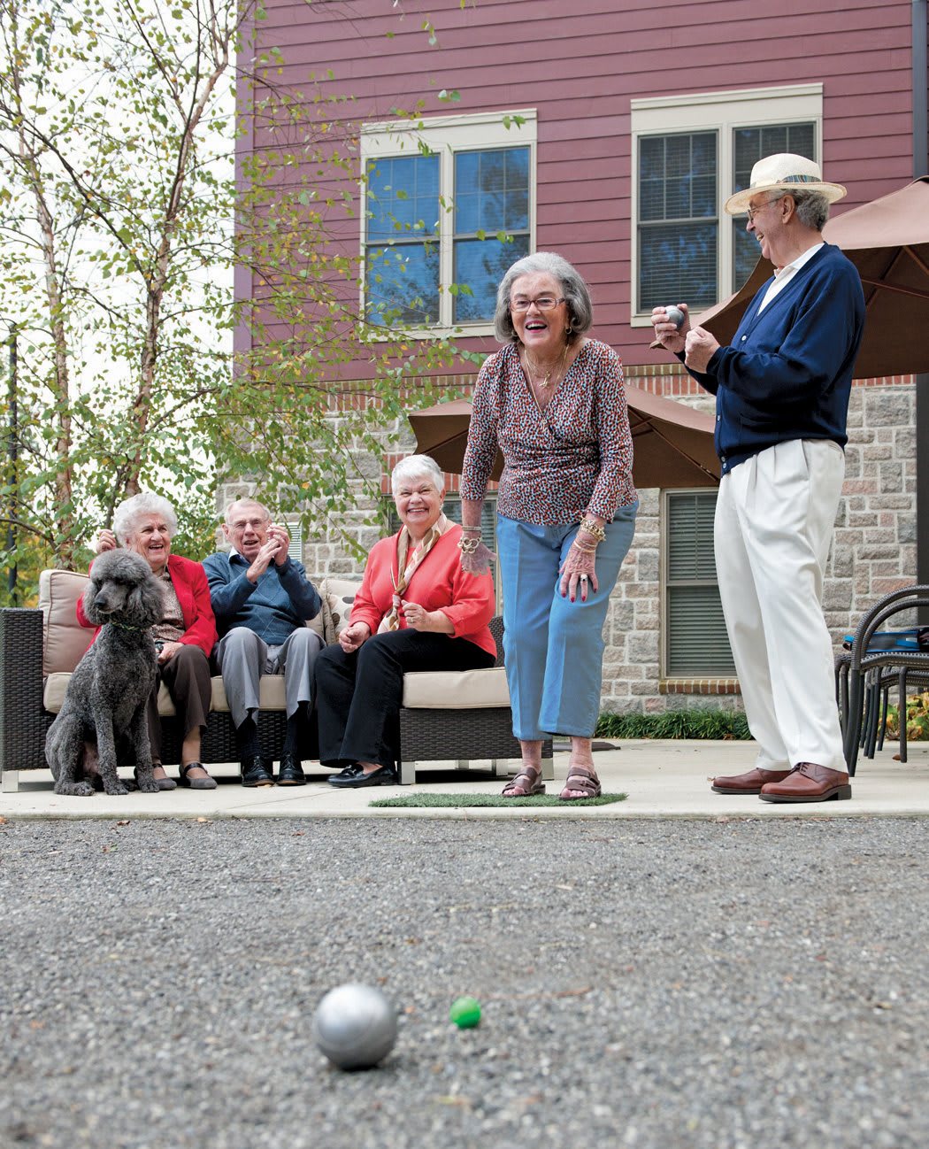 A group of seniors enjoying a game of bocce ball outdoors.