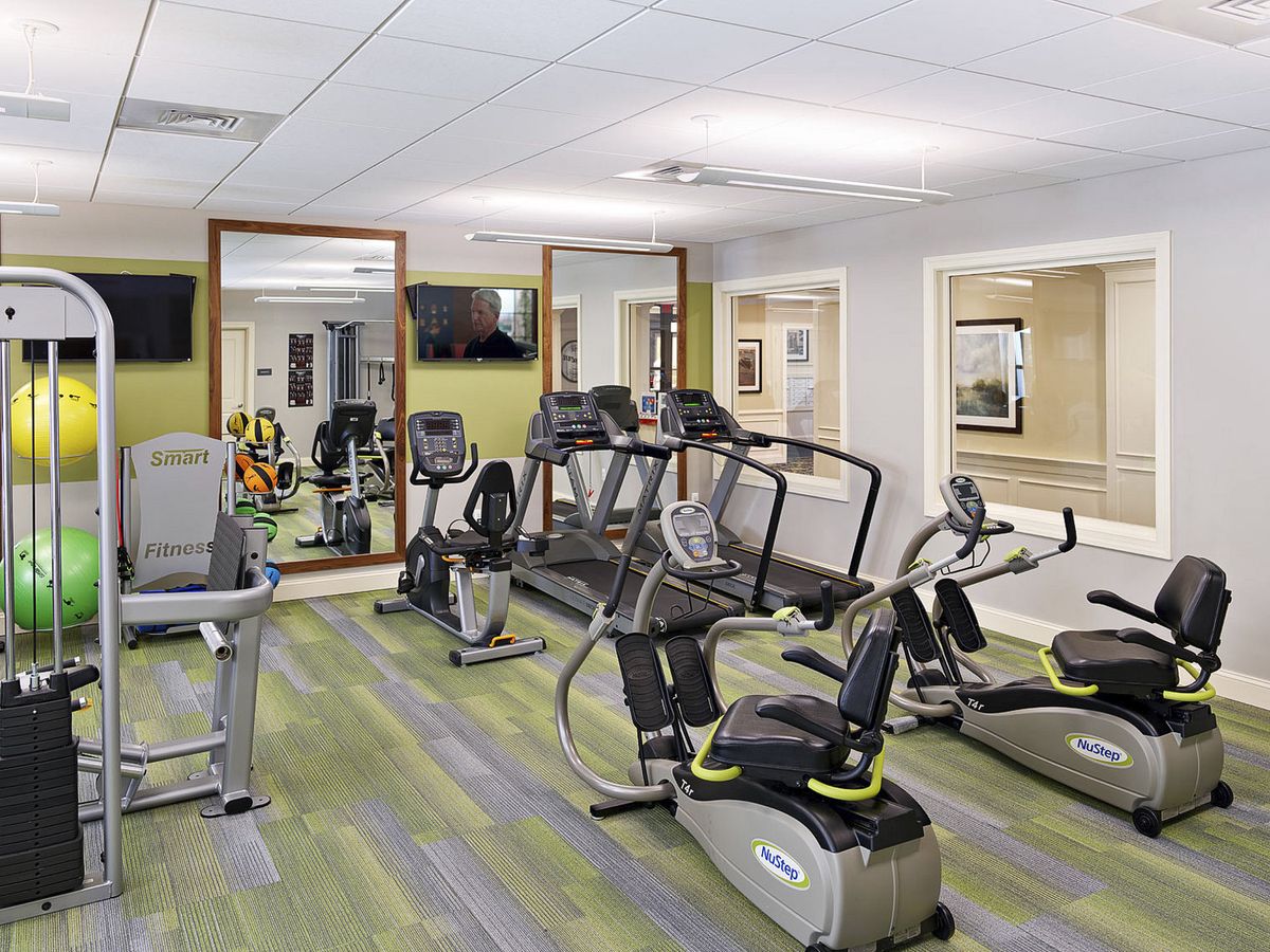 A modern fitness center equipped with treadmills and exercise bikes.