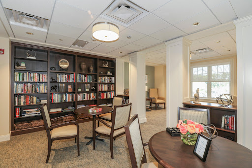 A cozy office space featuring a reading area with bookshelves and comfortable seating.