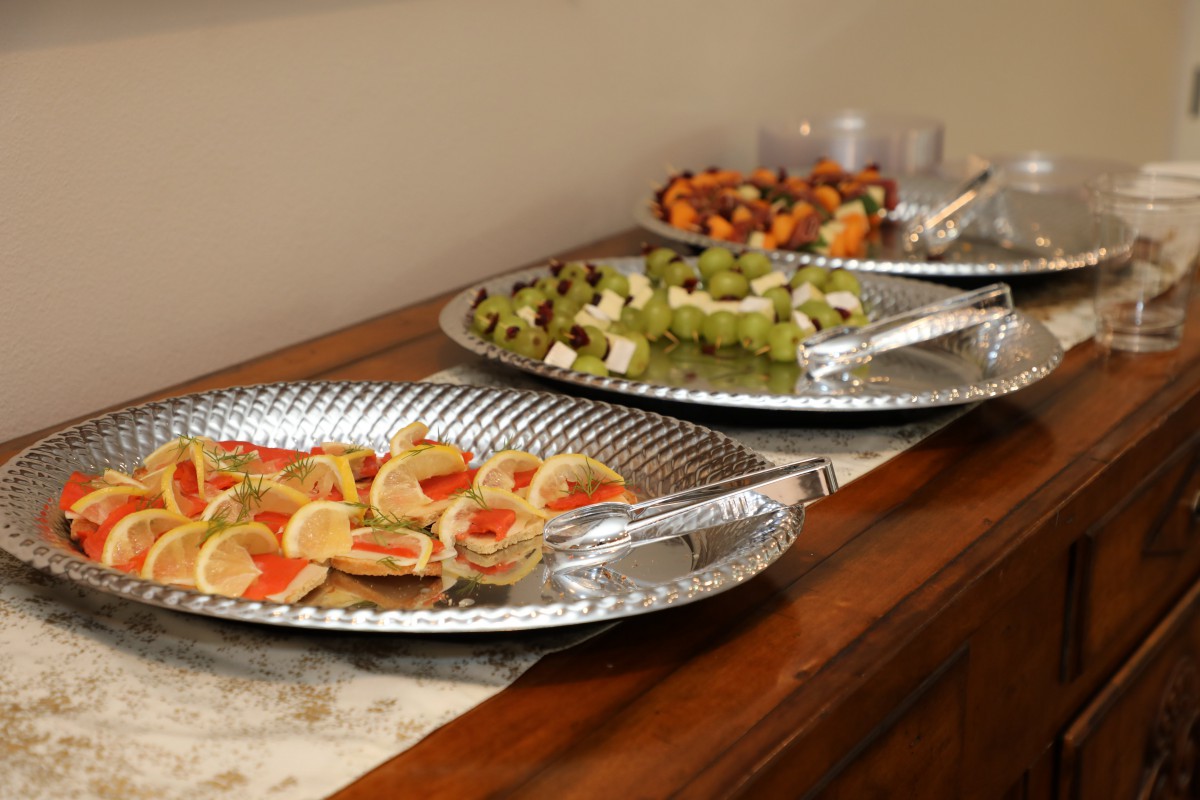 A buffet display featuring assorted appetizers and fruit platters.