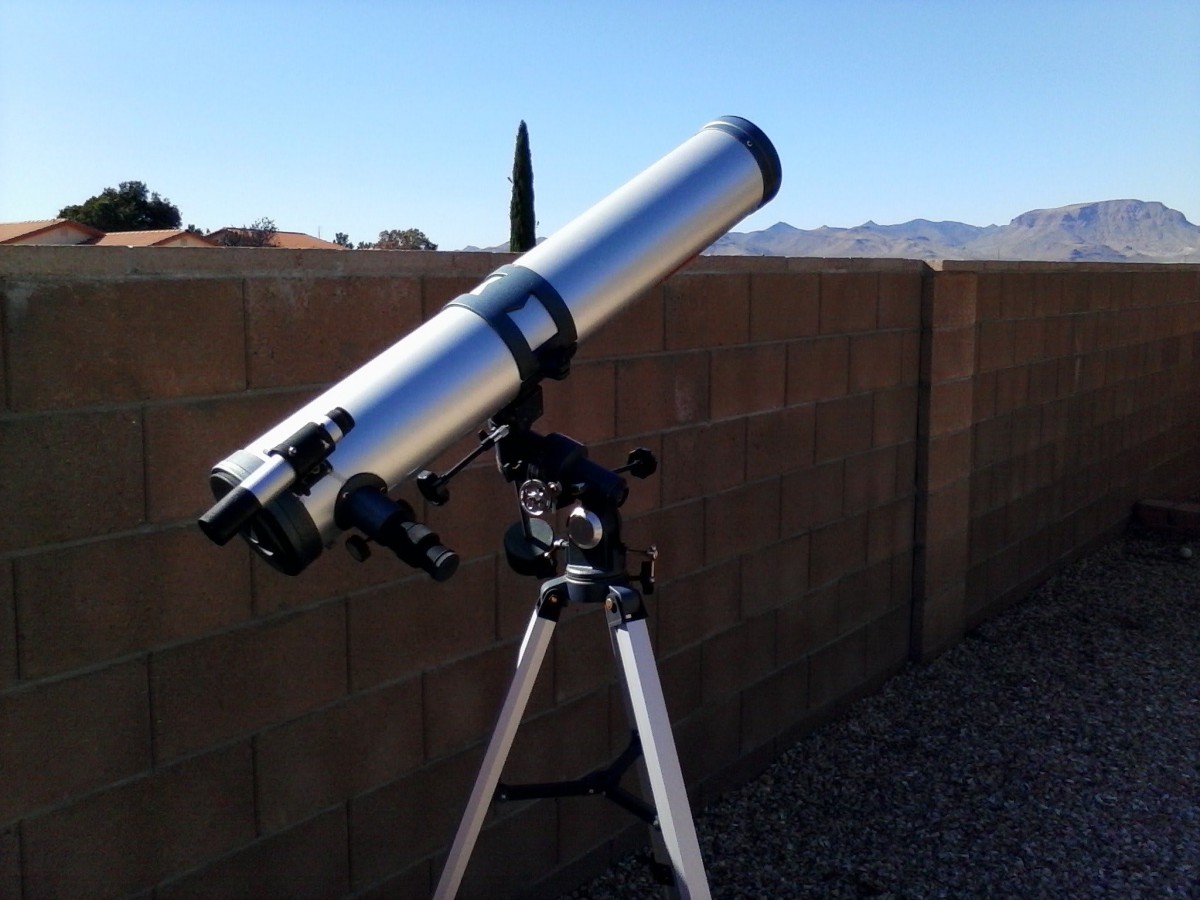 A telescope set up outdoors on a clear day, ready for stargazing.
