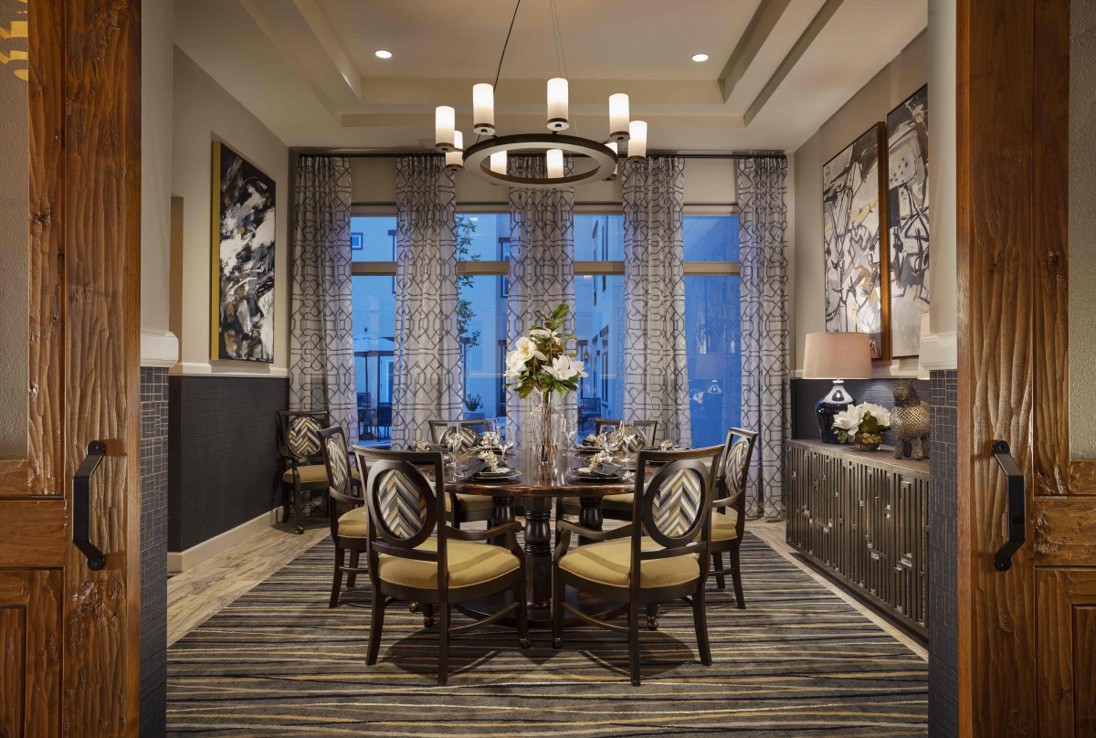 A beautifully decorated dining room with elegant furnishings and wall art.