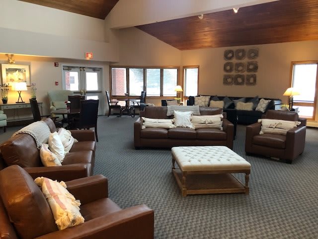 A spacious and cozy living room with comfortable seating arrangements and warm decor.
