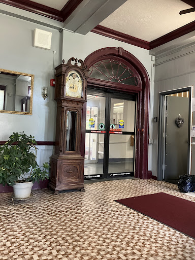 A beautifully decorated lobby featuring a classic grandfather clock and elegant tile flooring.
