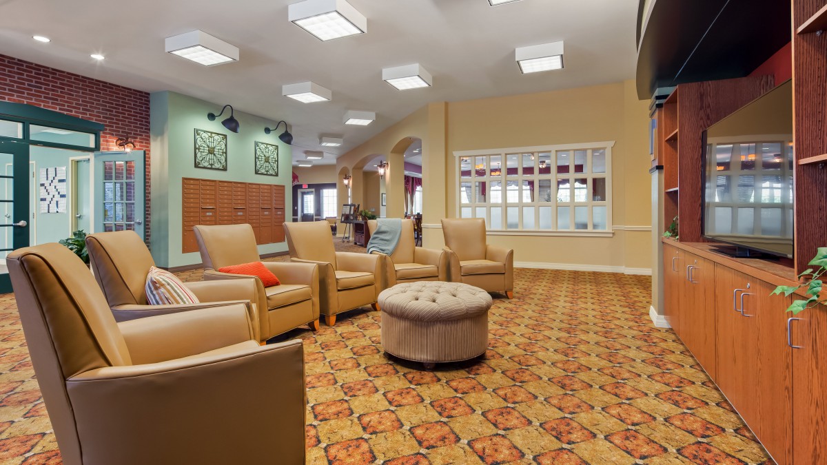 A comfortable and spacious lobby area with multiple seating options and warm lighting.