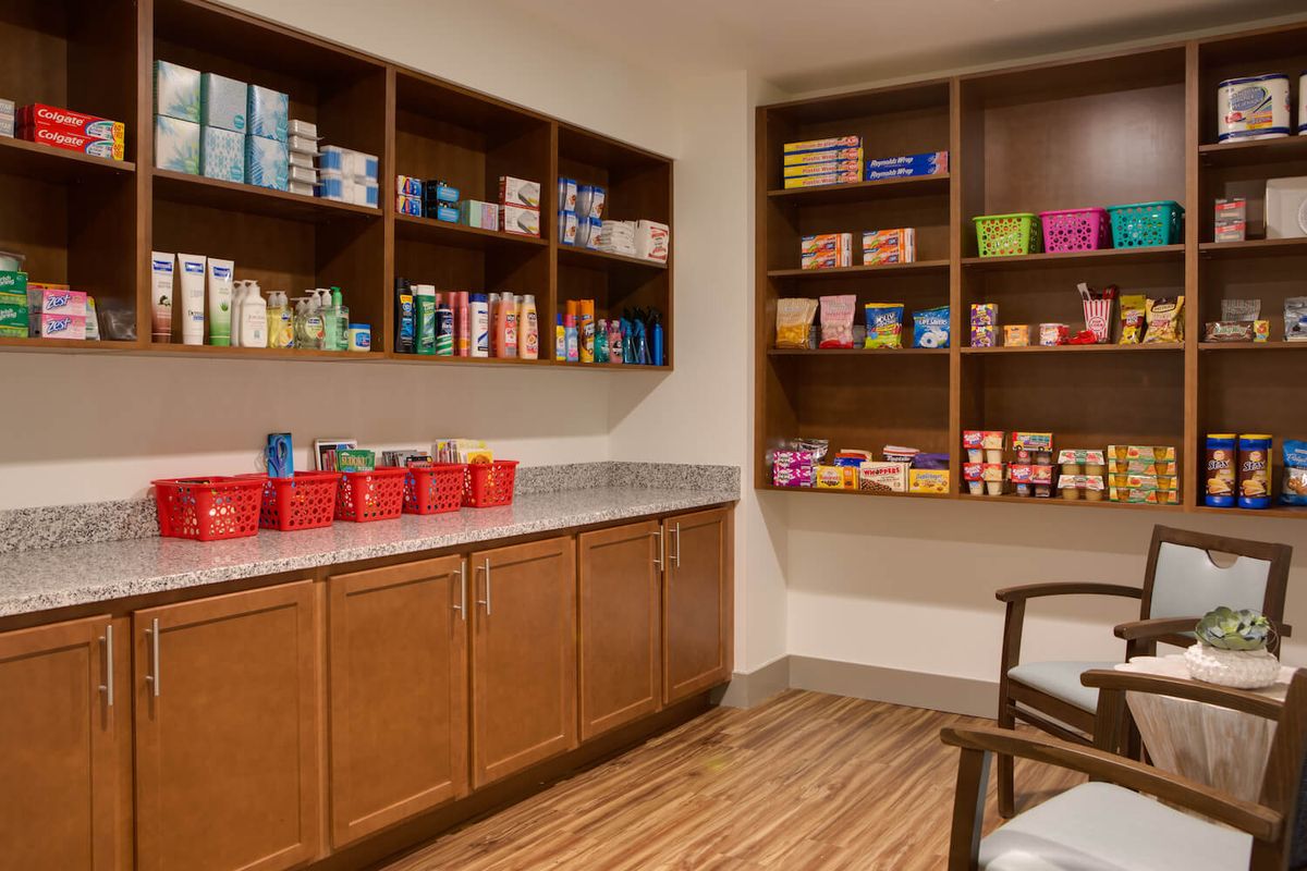 A well-organized pantry with stocked shelves and wooden cabinets.